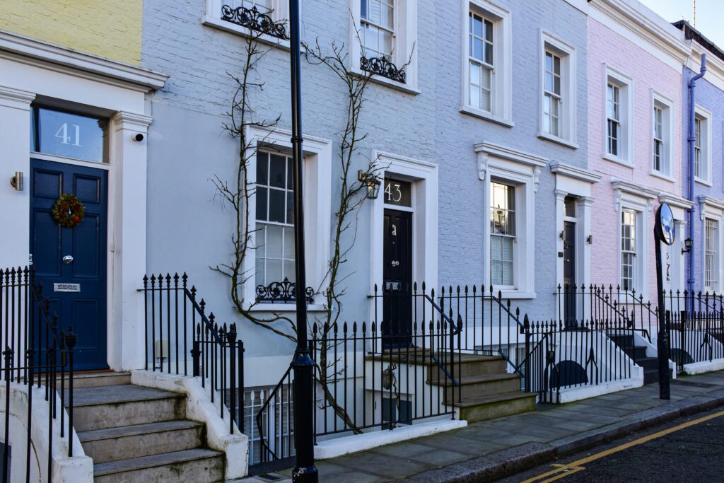 Charming pastel-colored terraced houses in London with classic Georgian architecture.