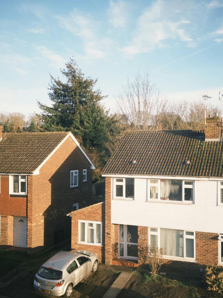 Charming suburban houses with cars in a peaceful Canterbury neighborhood, captured in daylight.