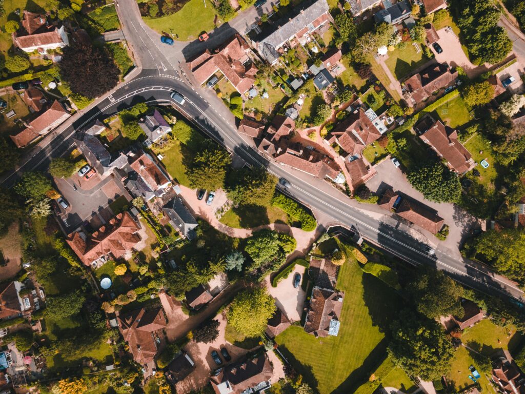 Aerial photo capturing the lush greenery and rooftops of Singleton, England on a sunny day.
