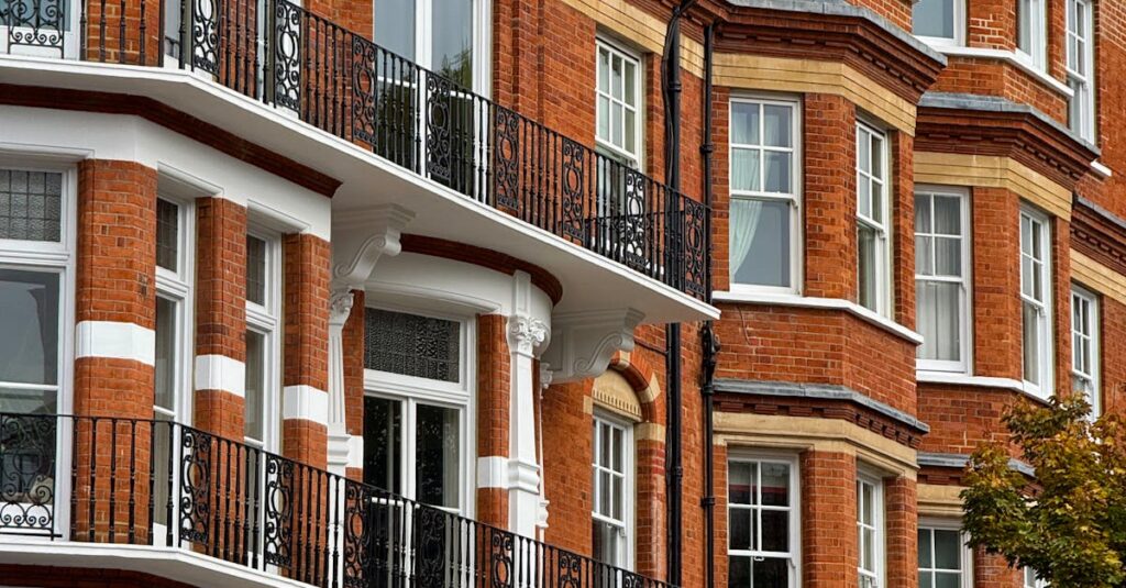 Classic red brick architecture with ornate balconies in Kensington, London.